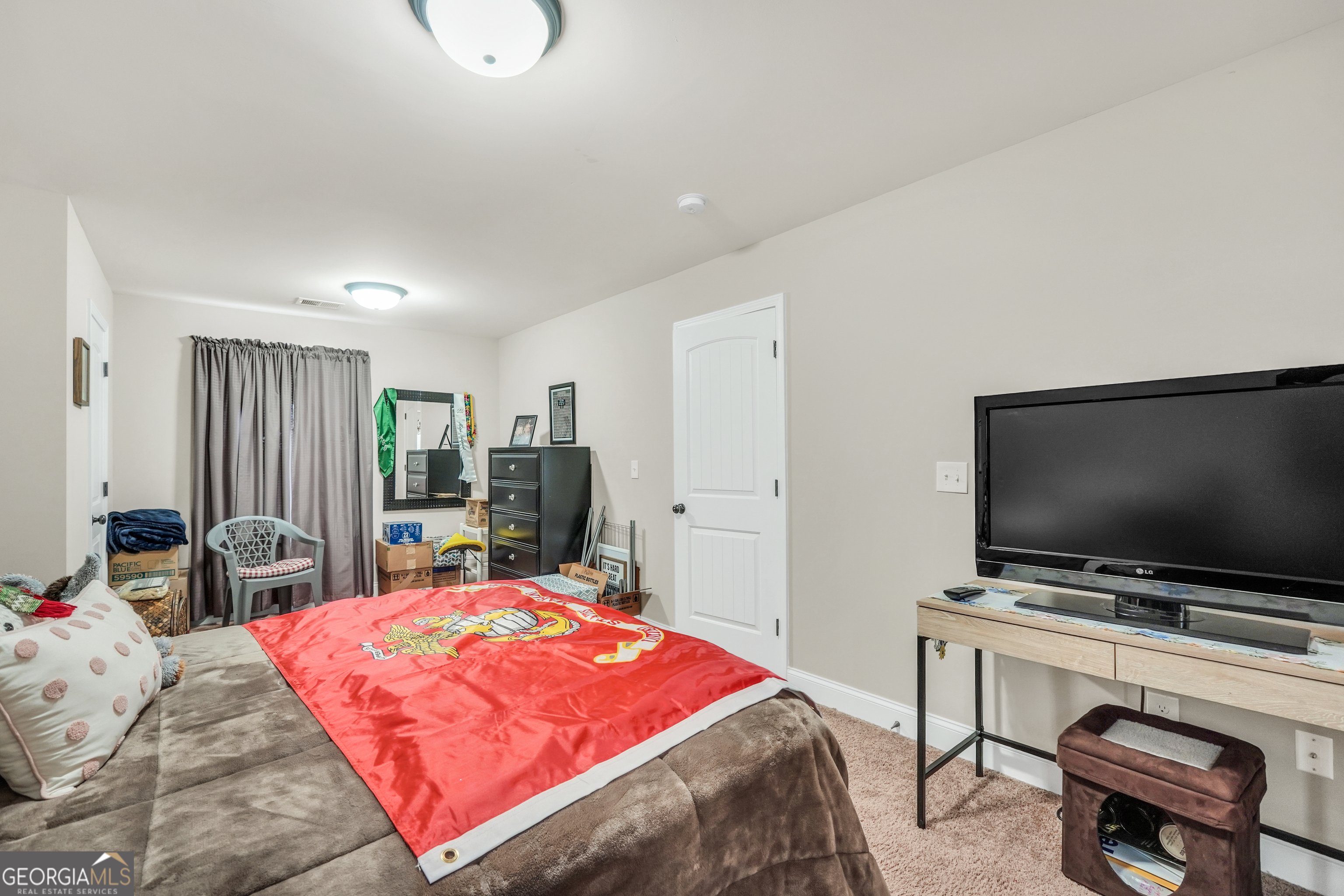 185 Wynn Road McDonough, GA 30252 - Photo 15 of 36 a bedroom with a bed and a flat screen tv