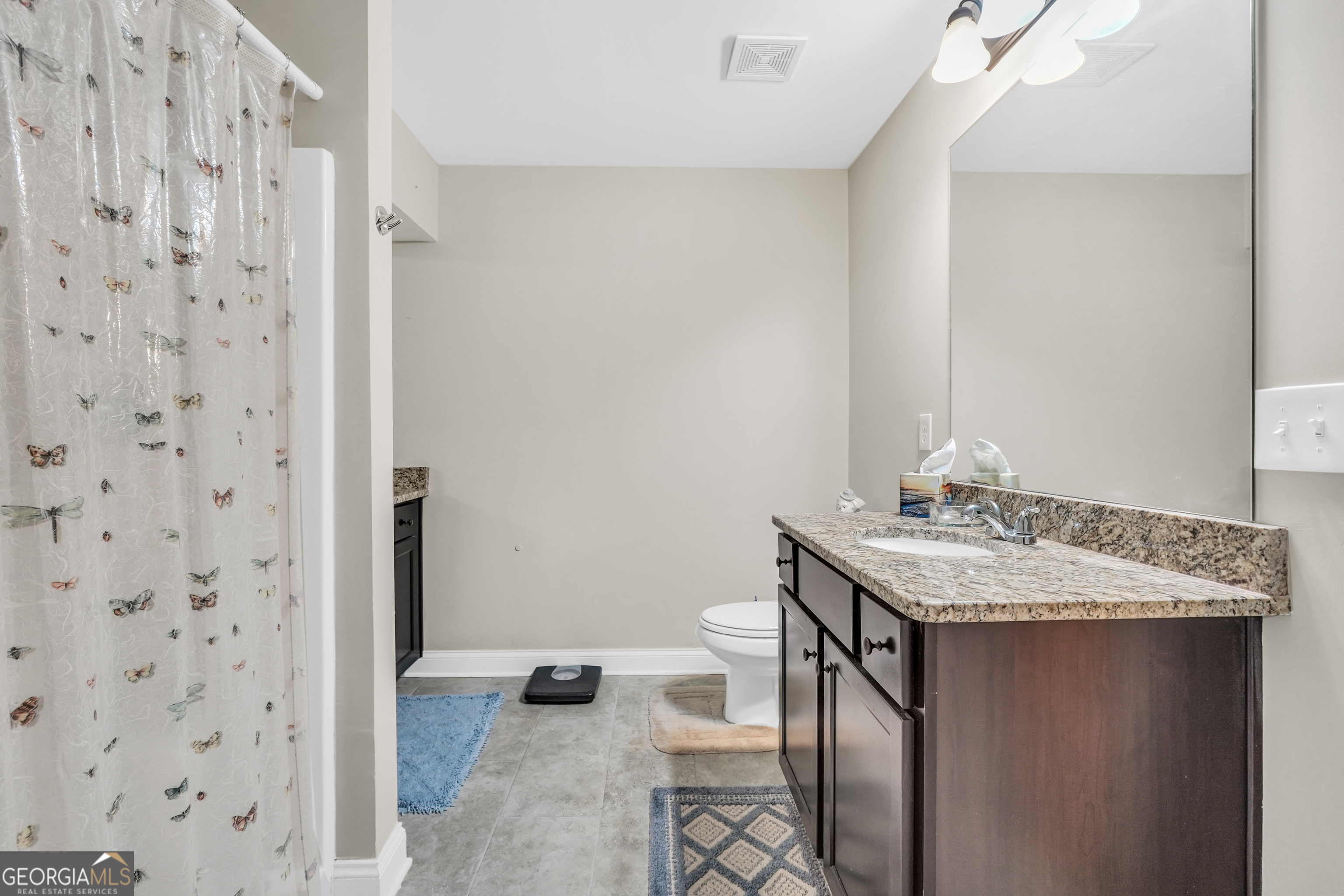 185 Wynn Road McDonough, GA 30252 - Photo 19 of 36 a bathroom with a granite countertop sink a toilet and shower