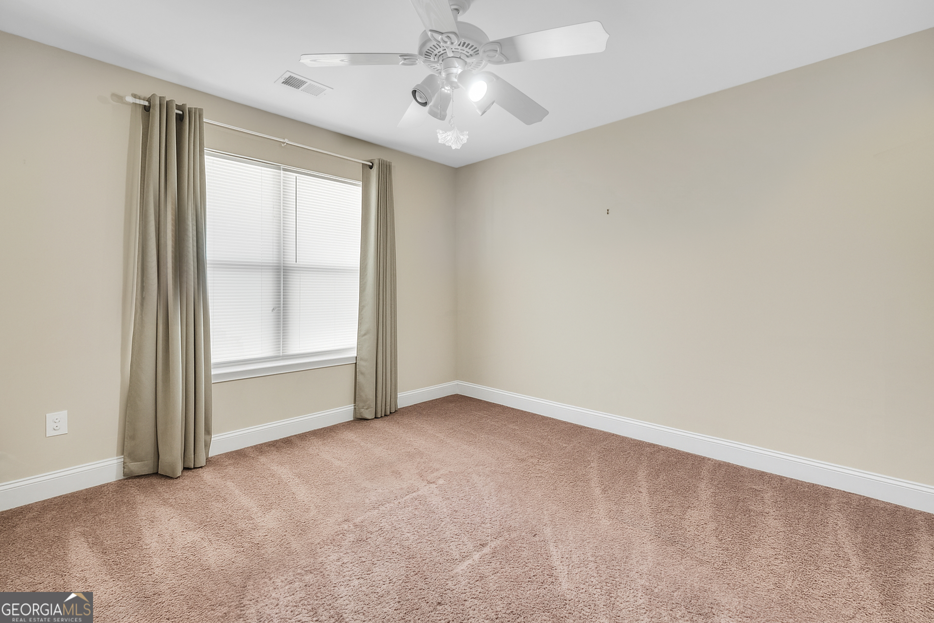 185 Wynn Road McDonough, GA 30252 - Photo 23 of 36 an empty room with chandelier fan and windows