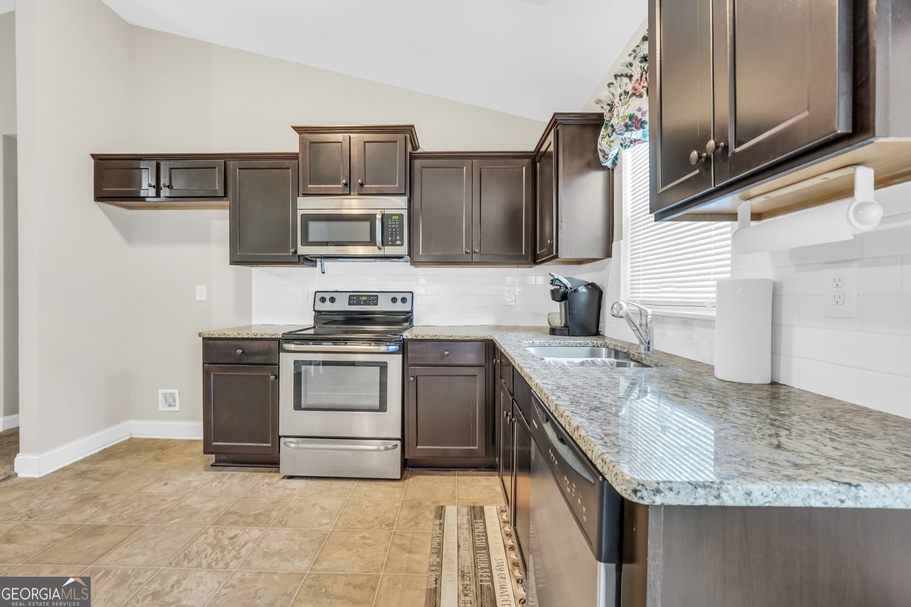 185 Wynn Road McDonough, GA 30252 - Photo 8 of 36 a kitchen with granite countertop a stove sink and microwave
