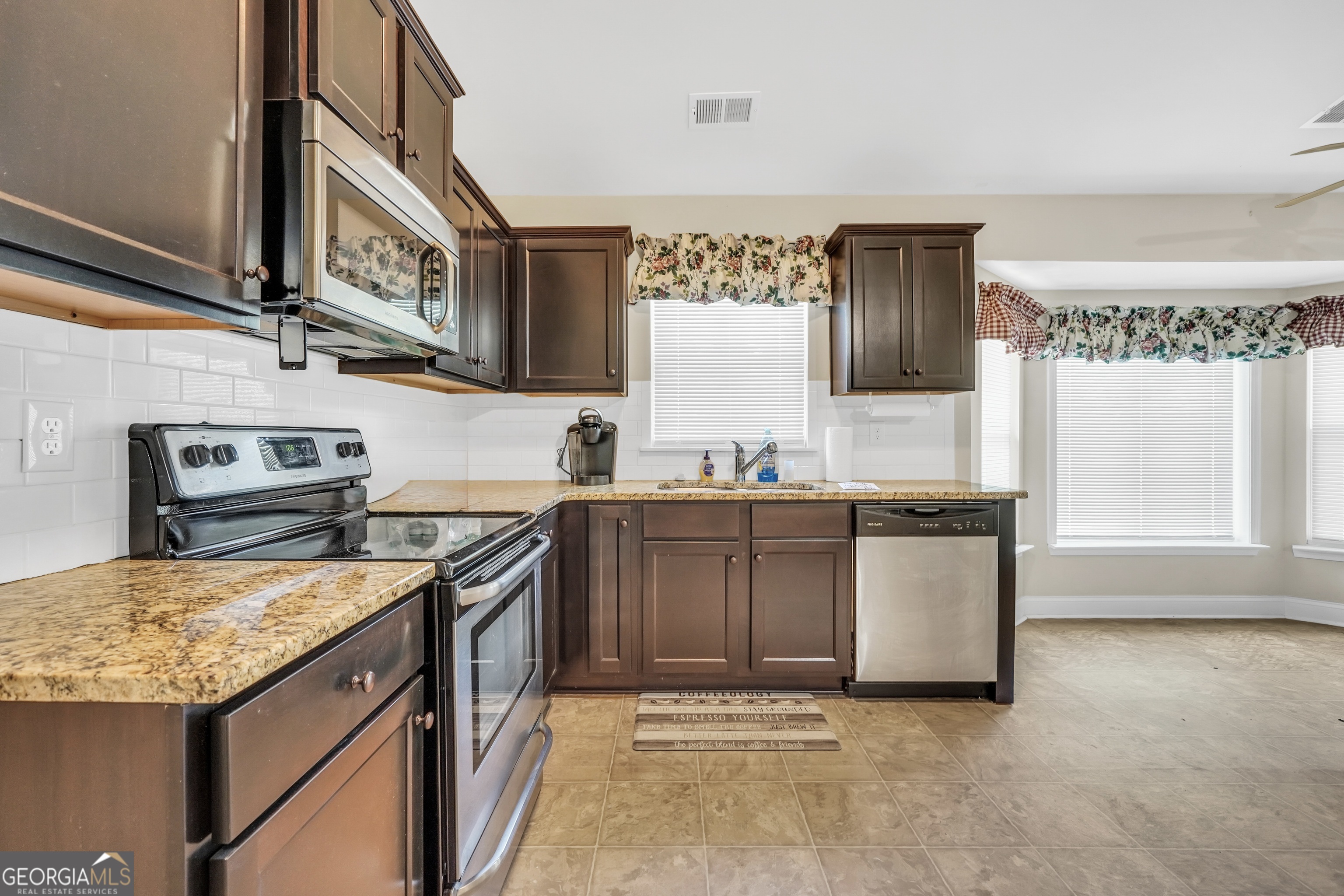 185 Wynn Road McDonough, GA 30252 - Photo 9 of 36 a kitchen with granite countertop a sink stove and cabinets