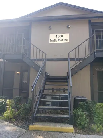 a bedroom with bed and a chandelier