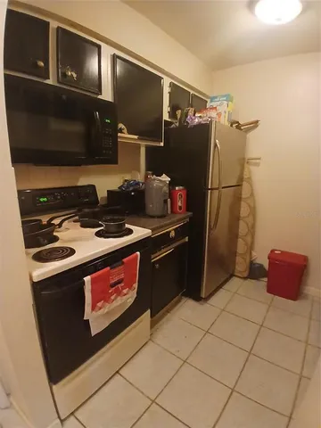a kitchen with a sink and a stove top oven