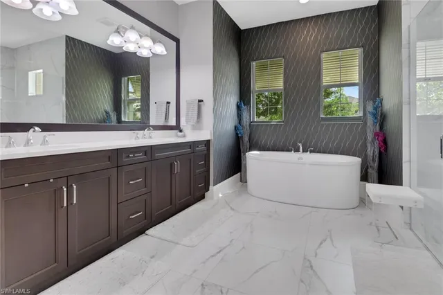 a spacious bathroom with a tub sink and mirror