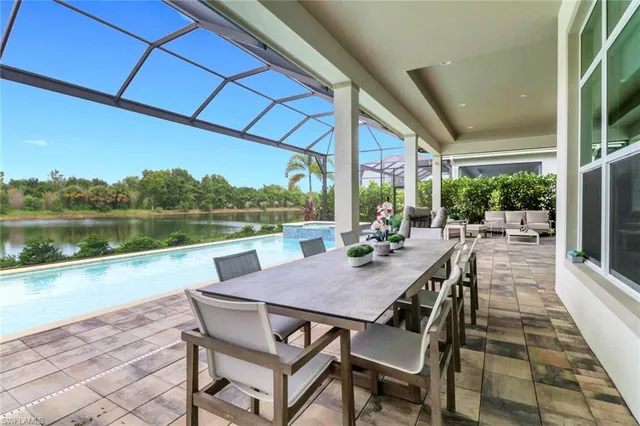 a view of a patio with table and chairs and couches with wooden floor