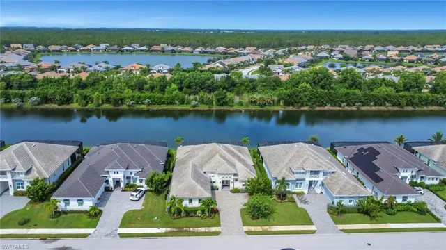 an aerial view of a house with outdoor space and lake view