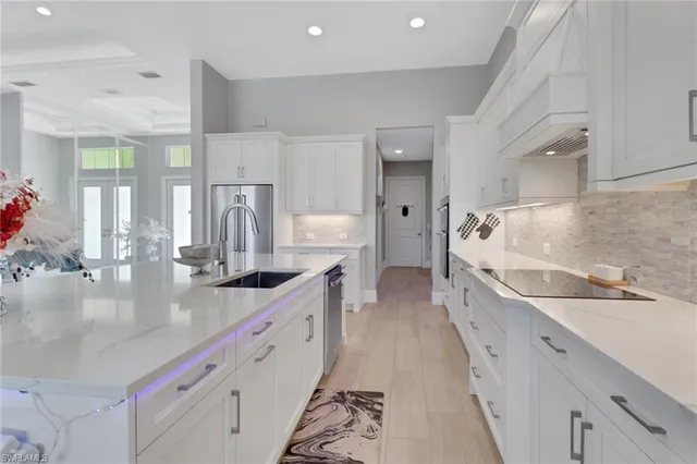 a large white kitchen with a large window
