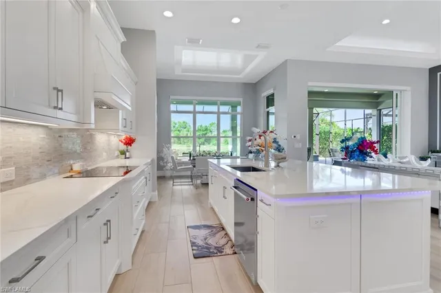 a kitchen with granite countertop a sink stove and cabinets