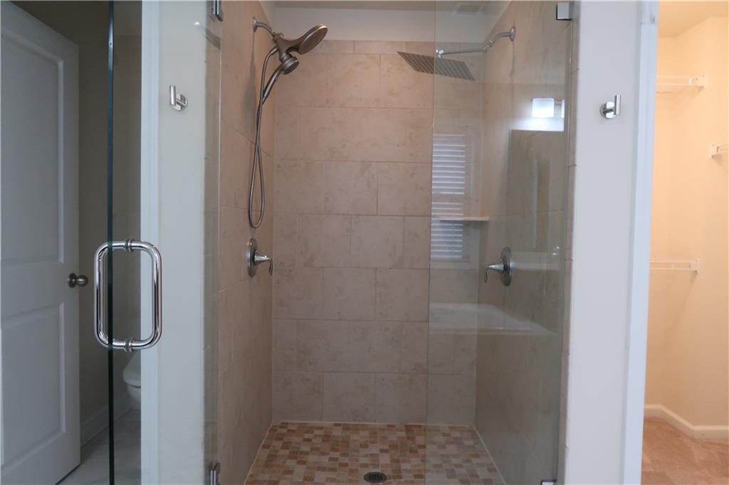 4334 Bellview Lane Duluth, GA 30097 - Photo 16 of 27 a bathroom with a glass shower door