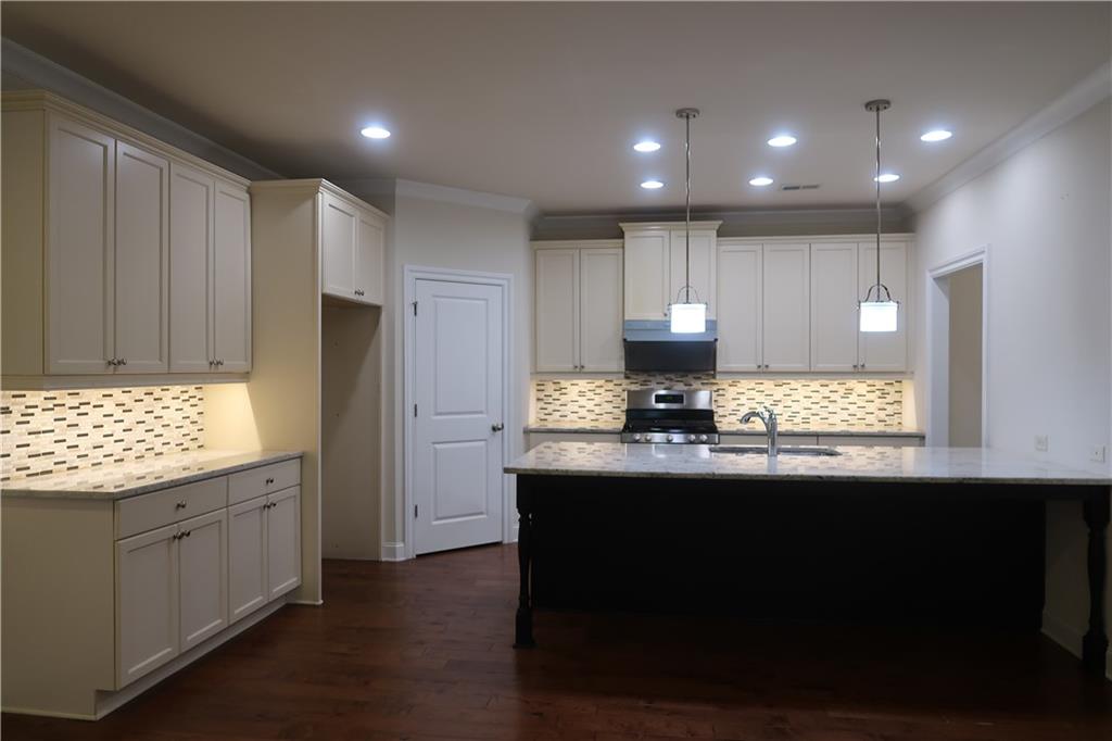 4334 Bellview Lane Duluth, GA 30097 - Photo 5 of 27 a kitchen with kitchen island granite countertop a sink cabinets and stainless steel appliances