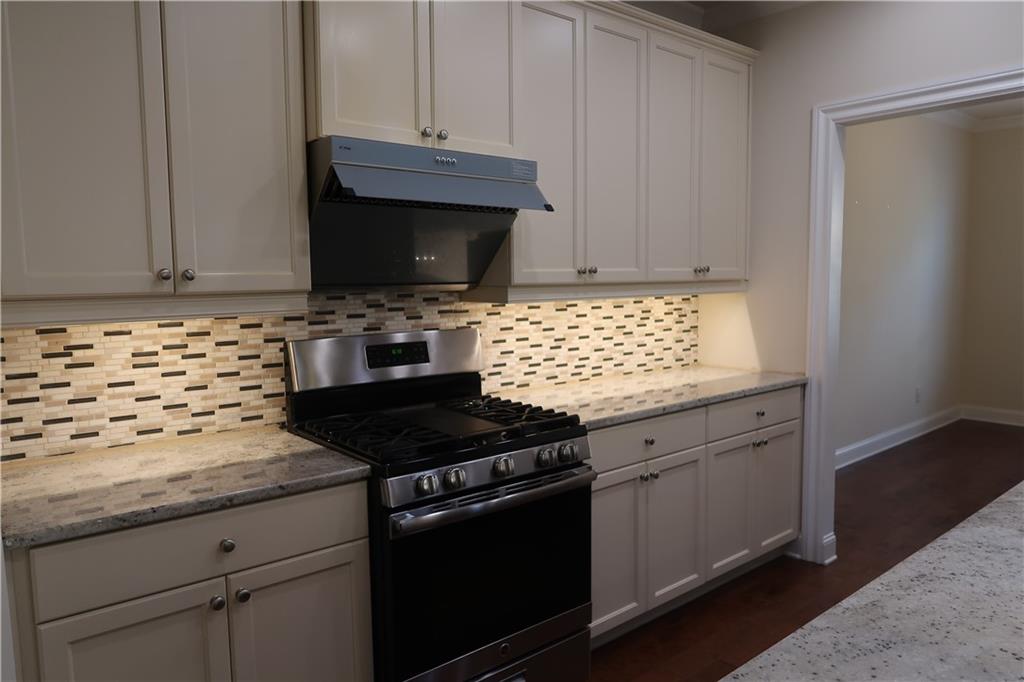 4334 Bellview Lane Duluth, GA 30097 - Photo 6 of 27 a kitchen with granite countertop cabinets and a stove top oven