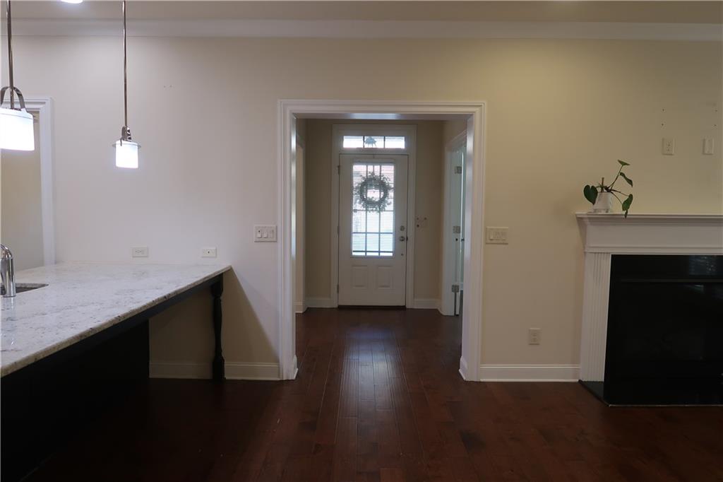 4334 Bellview Lane Duluth, GA 30097 - Photo 9 of 27 a view of an empty room with wooden floor and a fireplace