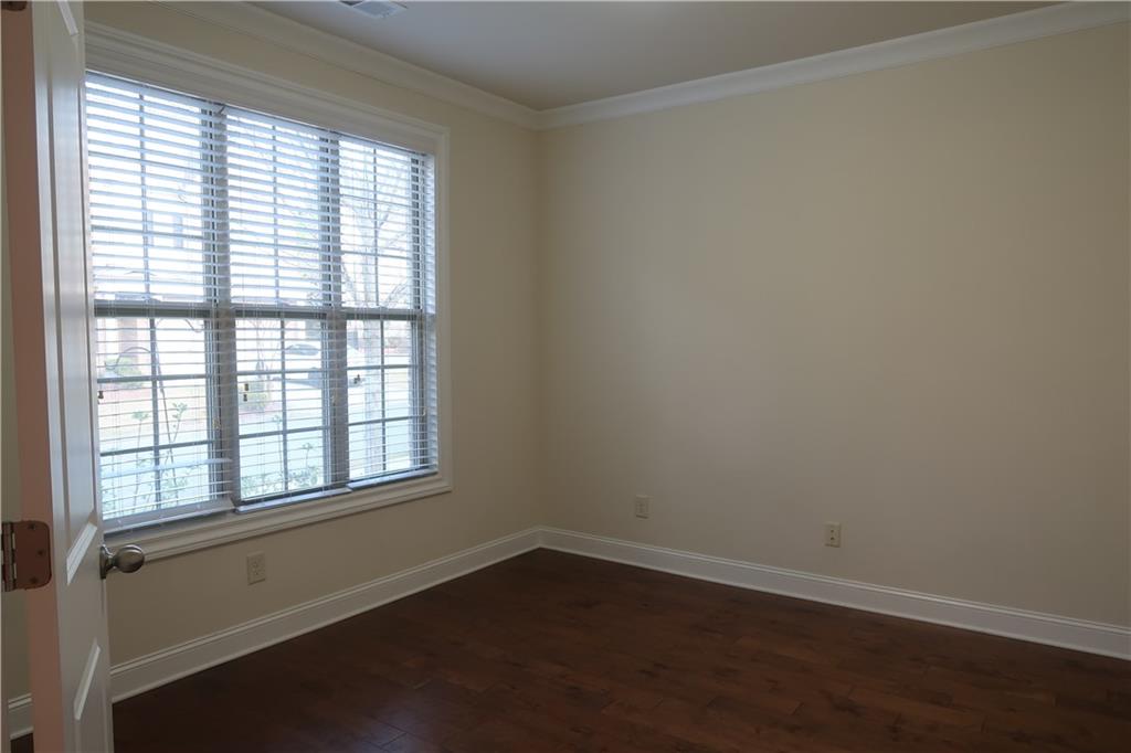 4334 Bellview Lane Duluth, GA 30097 - Photo 10 of 27 an empty room with wooden floor and windows