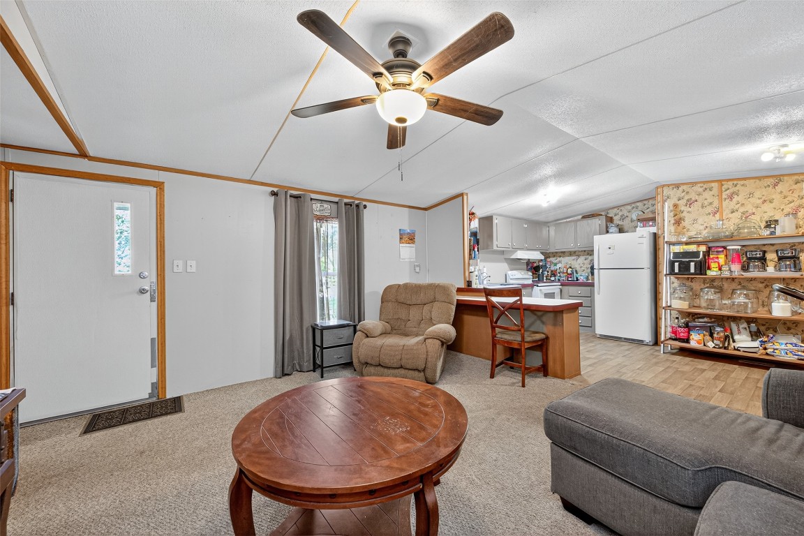 14 County Road 2400 Hull, TX 77564 - Photo 11 of 38 a living room with furniture and kitchen view
