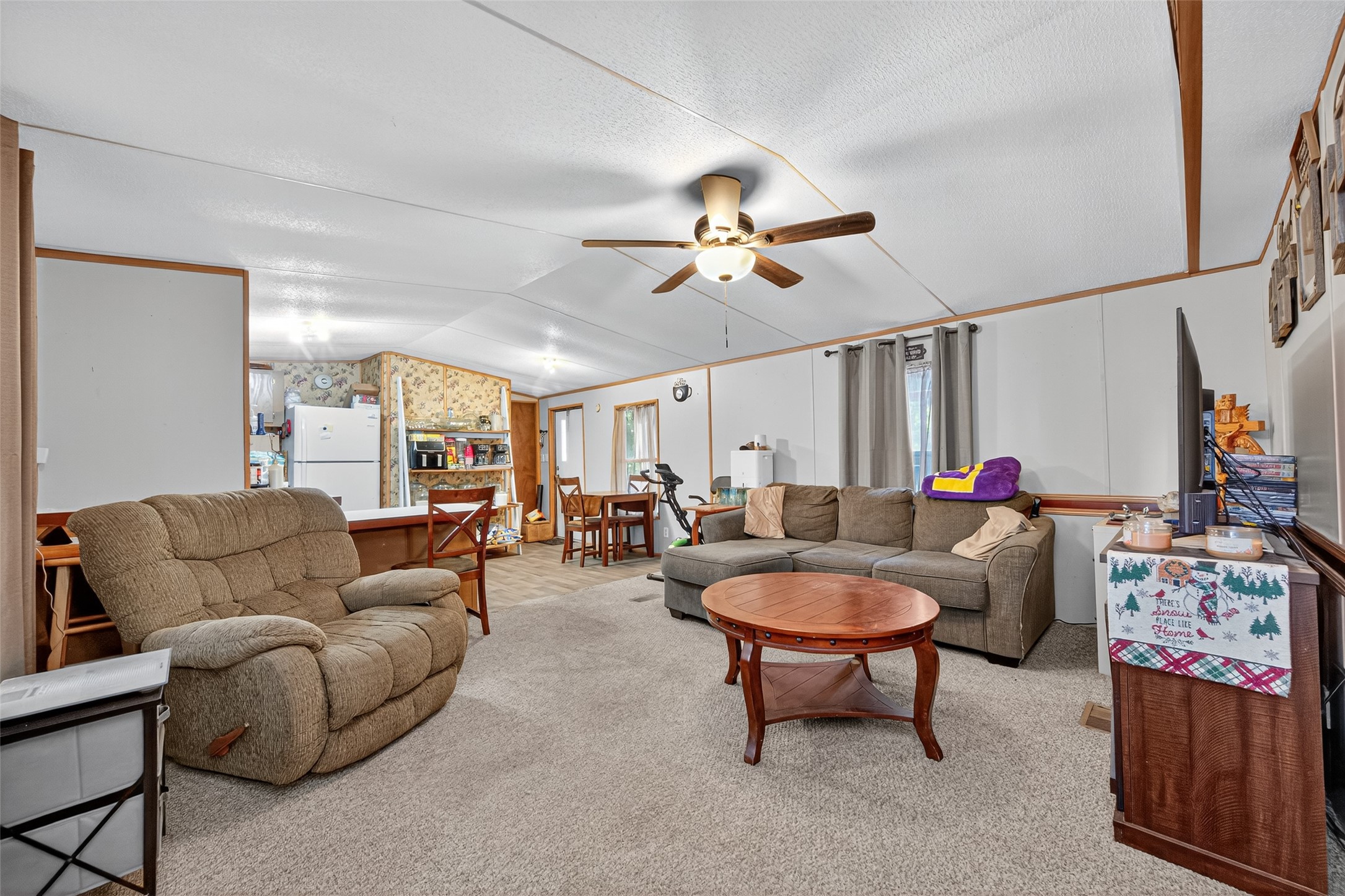 14 County Road 2400 Hull, TX 77564 - Photo 12 of 38 a living room with furniture a rug and a chandelier