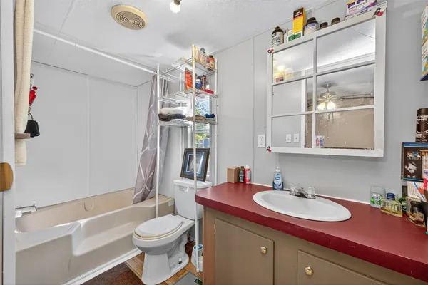 a bathroom with a sink vanity mirror and toilet