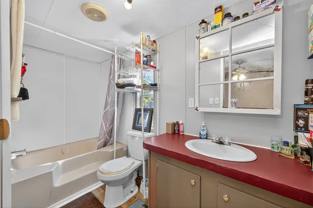 a bathroom with a sink vanity mirror and toilet