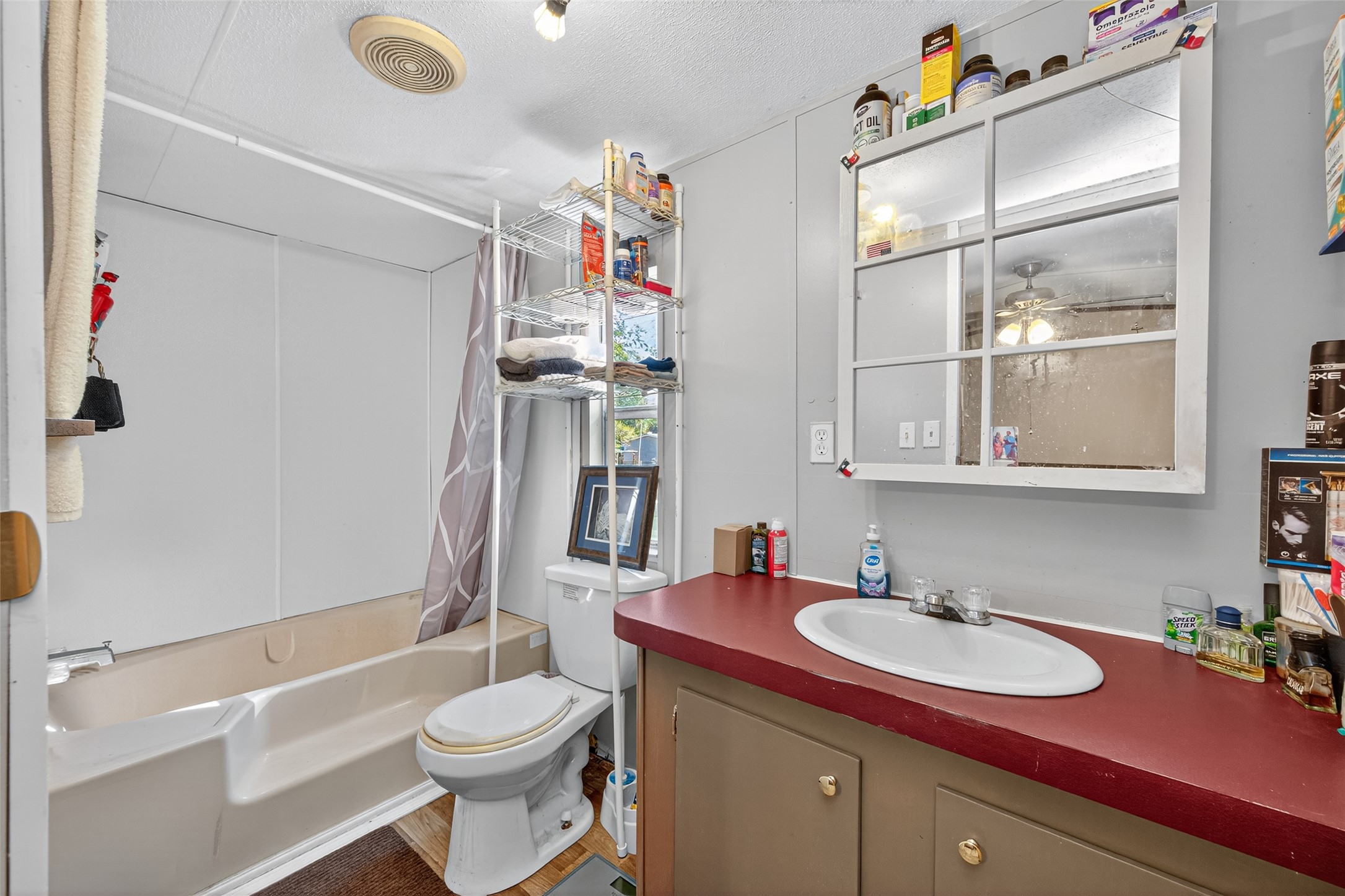 14 County Road 2400 Hull, TX 77564 - Photo 19 of 38 a bathroom with a sink vanity mirror and toilet