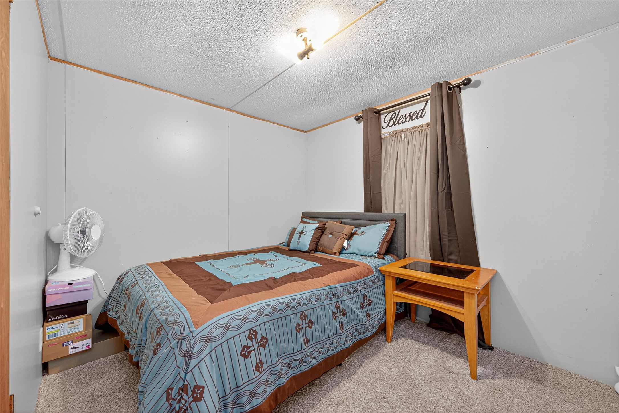 14 County Road 2400 Hull, TX 77564 - Photo 21 of 38 a bedroom with a bed and a chandelier