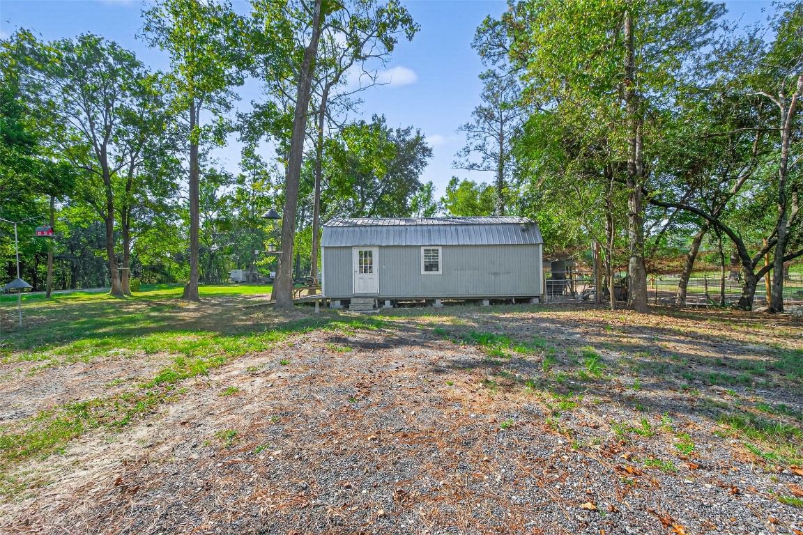 14 County Road 2400 Hull, TX 77564 - Photo 24 of 38 a view of a house with backyard and trees