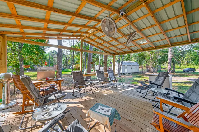 a view of a swimming pool with lounge chairs in patio
