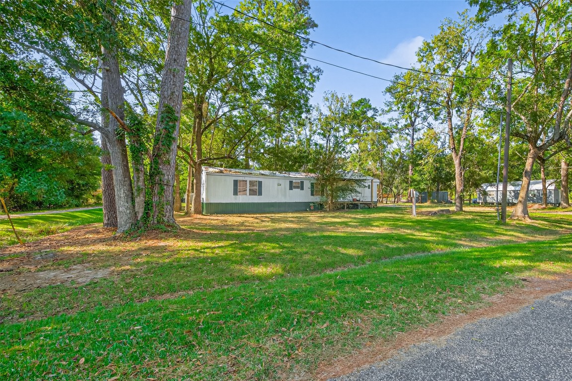 14 County Road 2400 Hull, TX 77564 - Photo 4 of 38 a front view of a house with a yard