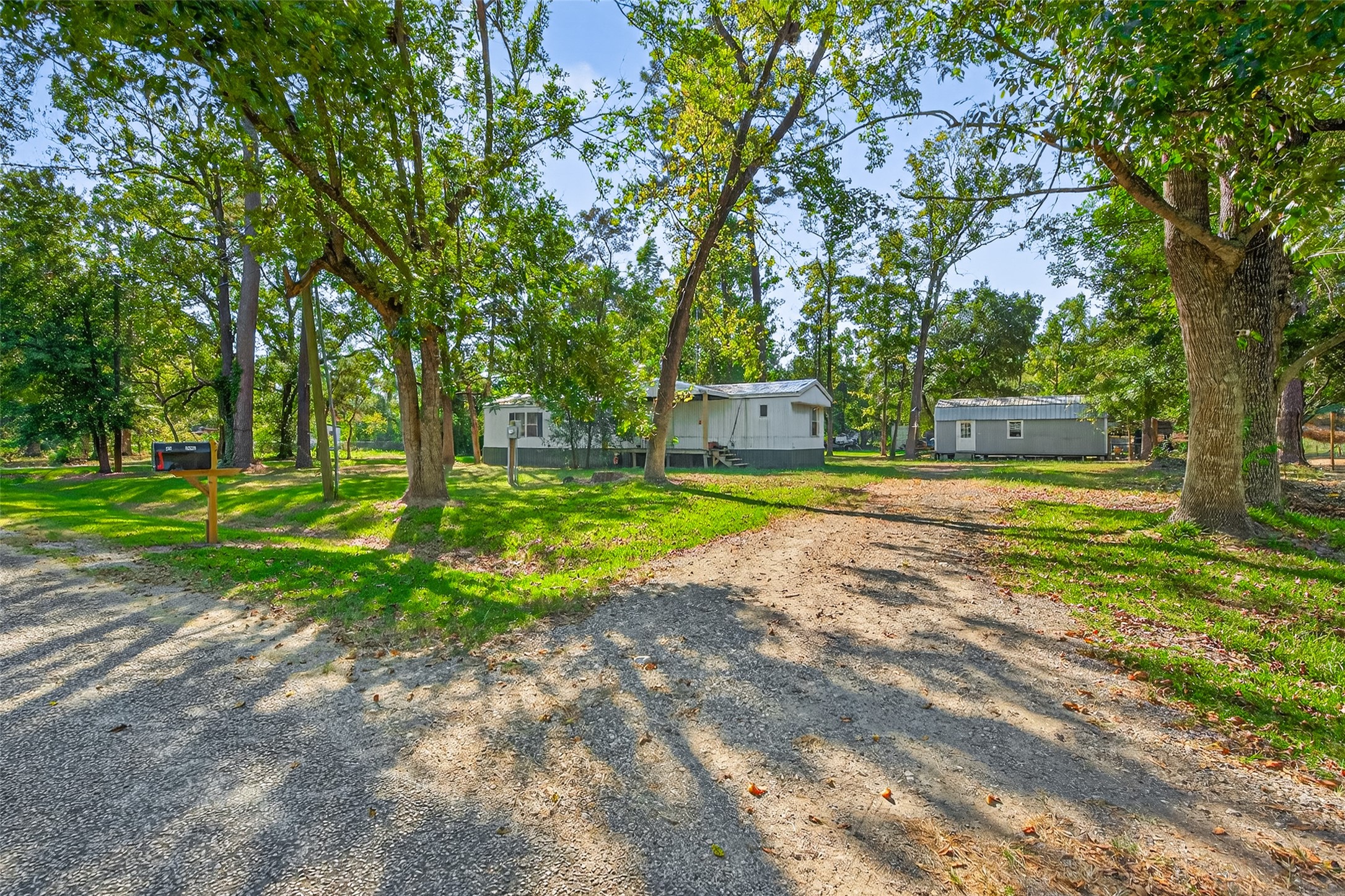 14 County Road 2400 Hull, TX 77564 - Photo 6 of 38 a view of a house with backyard and a tree