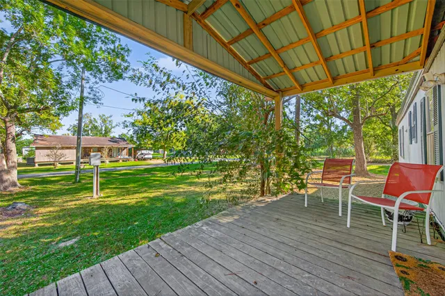 a view of a chair and table on the wooden deck