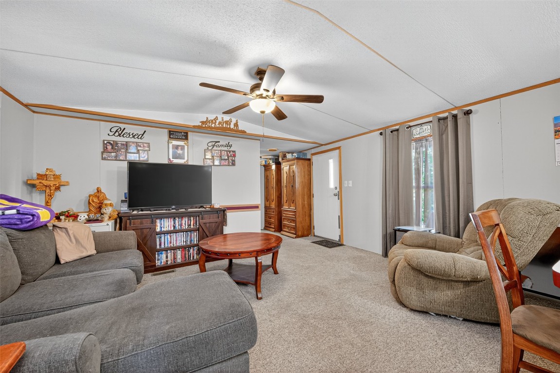 14 County Road 2400 Hull, TX 77564 - Photo 10 of 38 a living room with furniture and a flat screen tv