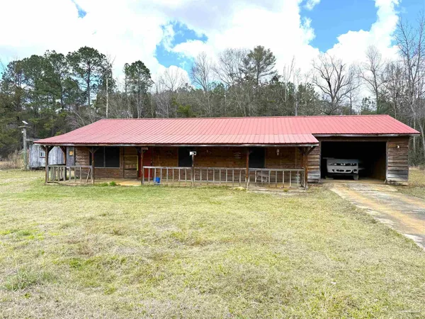 a view of a house with pool and a yard