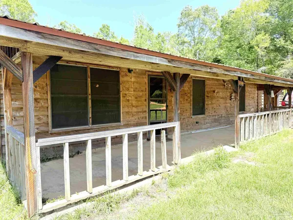 a view of a house with wooden fence