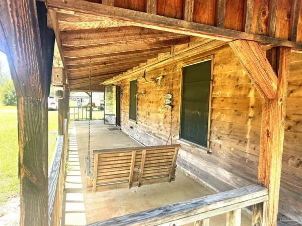 a view of a porch with a door and outside view