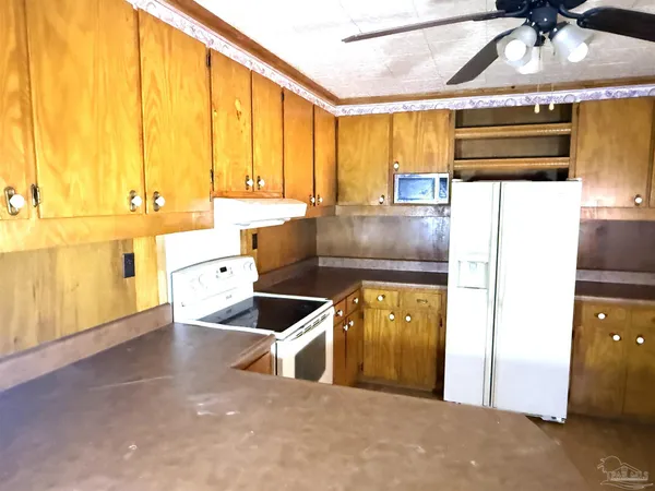 a kitchen with stainless steel appliances a sink a counter space and a window
