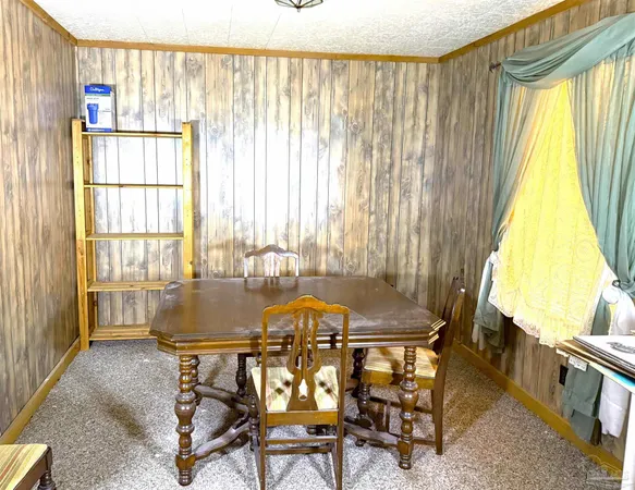a view of a dining room with furniture and a window