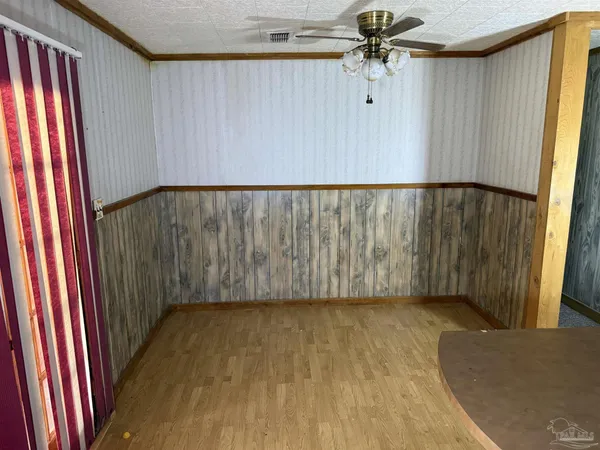 a view of a room with a window and a ceiling fan