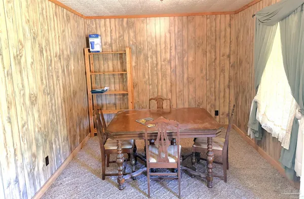 a dining room with furniture and a window