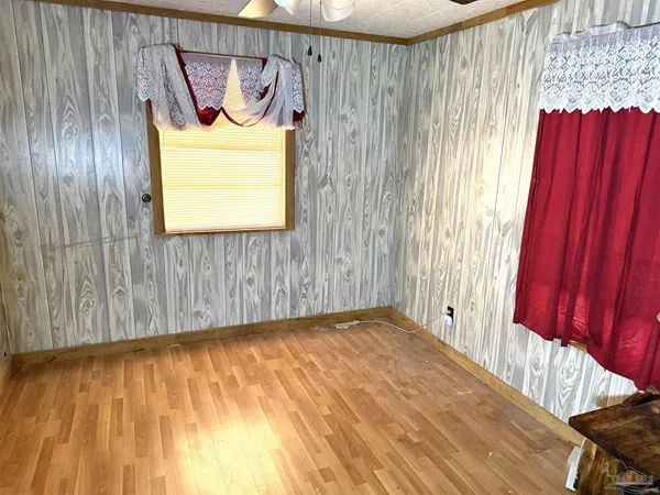 a view of a room with wooden floor and a window