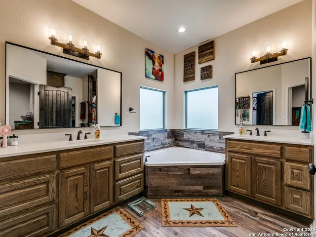 a large bathroom with a large tub sink and double vanity