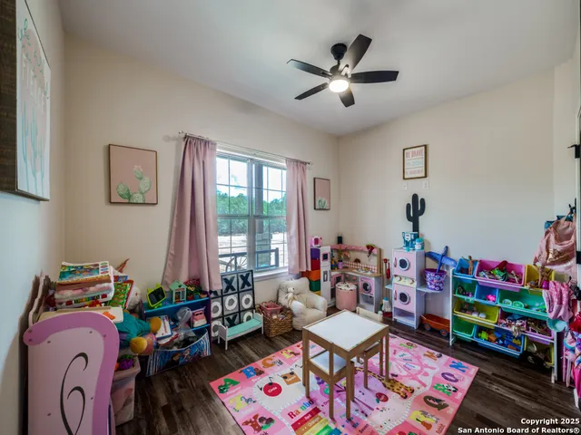 a play room with toys and a wooden floor