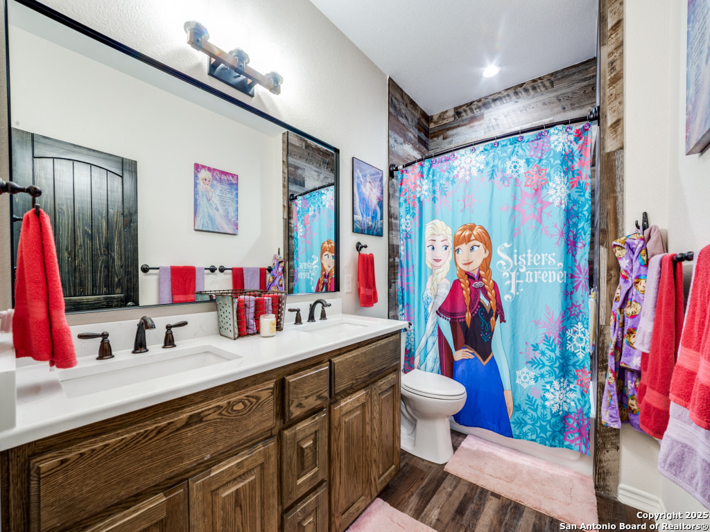 6451 Bluntzer Road Jourdanton, TX 78026 - Photo 18 of 51 a bathroom with a sink mirror vanity and toilet