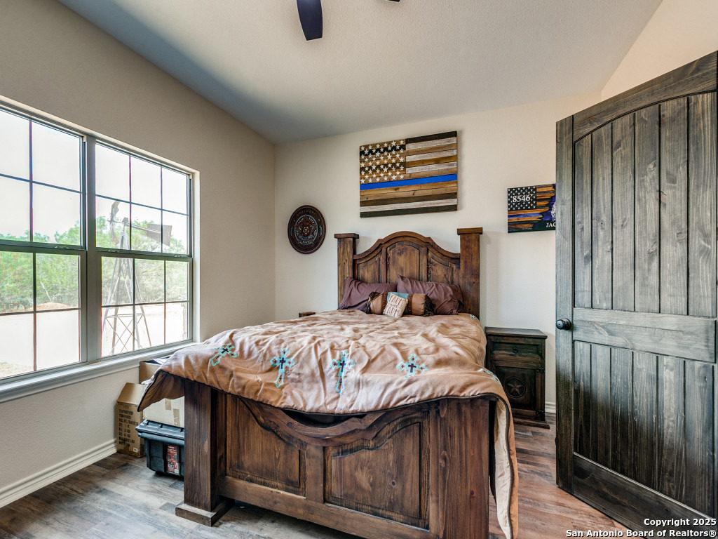 6451 Bluntzer Road Jourdanton, TX 78026 - Photo 19 of 51 a bedroom with a bed and a window