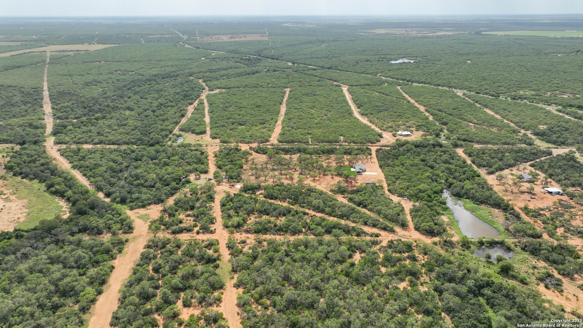 6451 Bluntzer Road Jourdanton, TX 78026 - Photo 39 of 51 an aerial view of residential houses with outdoor space