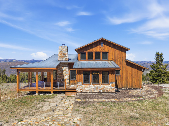 22677 East Snowbird Drive, Unit 47 Helper, UT 84526 - Photo 2 of 43 Rear view of property featuring a standing seam roof, stone siding, a deck with mountain view, and board and batten siding