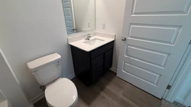 a bathroom with a toilet sink and mirror