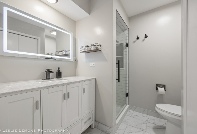 707 South Finley Road Lombard, IL 60148 - Photo 12 of 25 a bathroom with a sink a toilet and shower