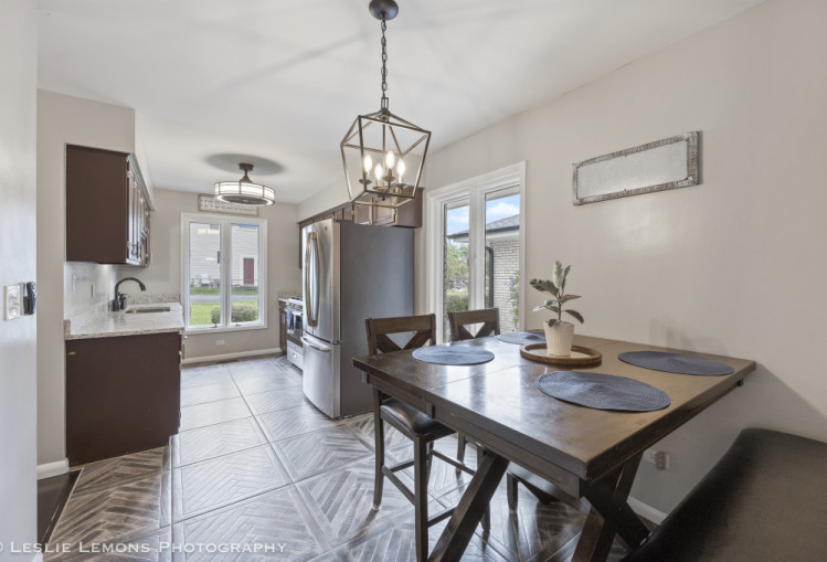 707 South Finley Road Lombard, IL 60148 - Photo 19 of 25 a view of a dining room and kitchen with a table chairs and chandelier