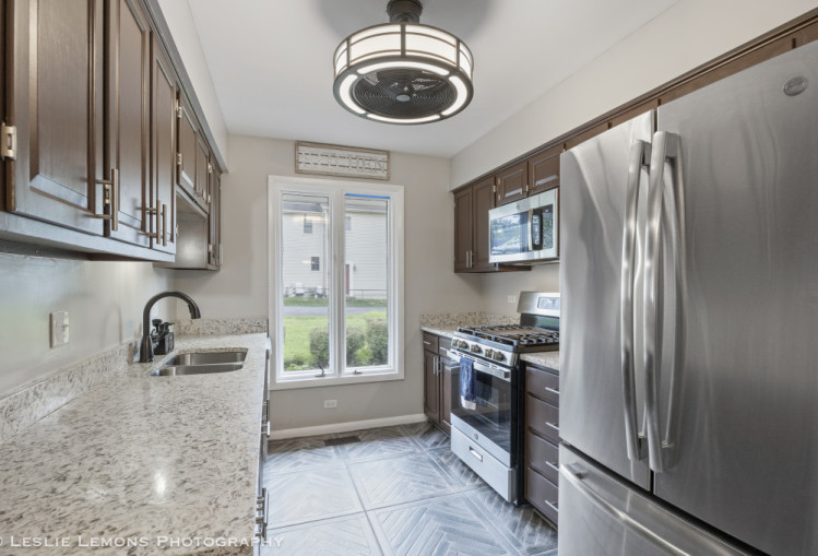 707 South Finley Road Lombard, IL 60148 - Photo 20 of 25 a kitchen with stainless steel appliances a stove a sink and a refrigerator
