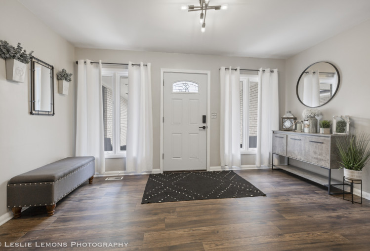 707 South Finley Road Lombard, IL 60148 - Photo 3 of 25 a living room with furniture a mirror and a rug