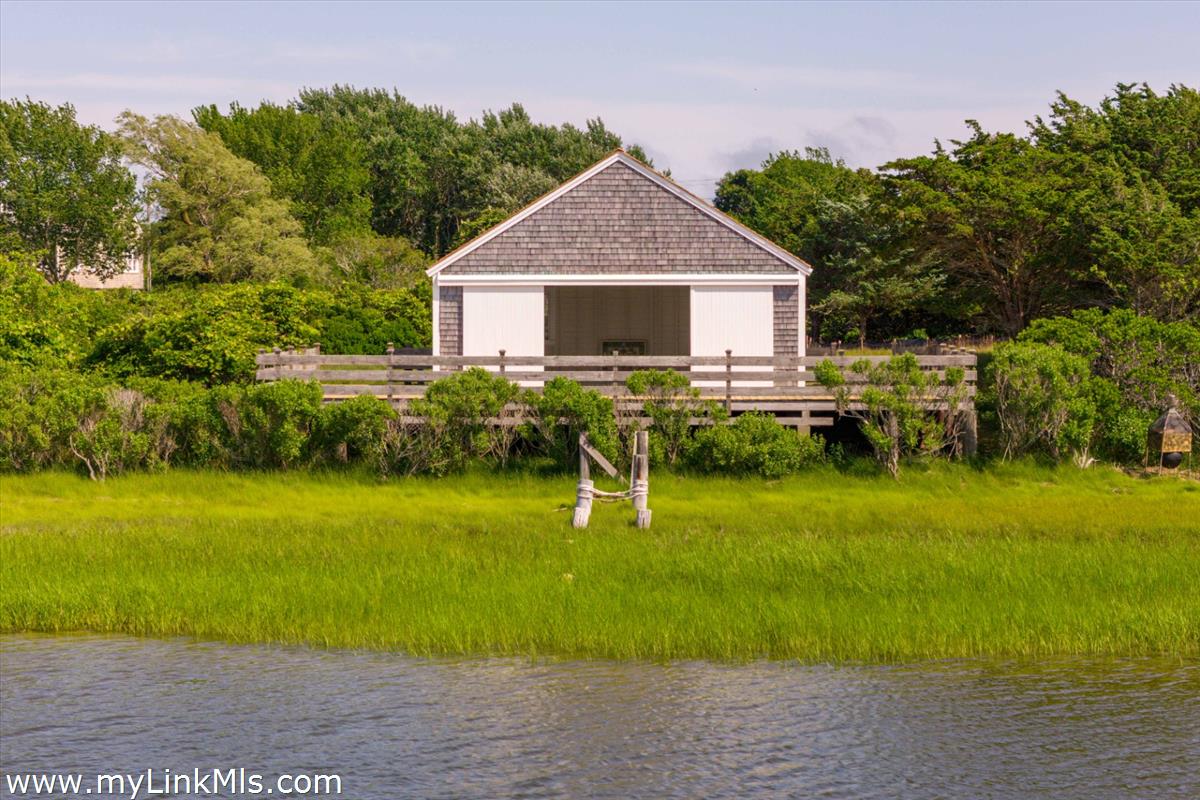 256 Polpis Road Nantucket, MA 02554 - Photo 26 of 30 a front view of a house with garden