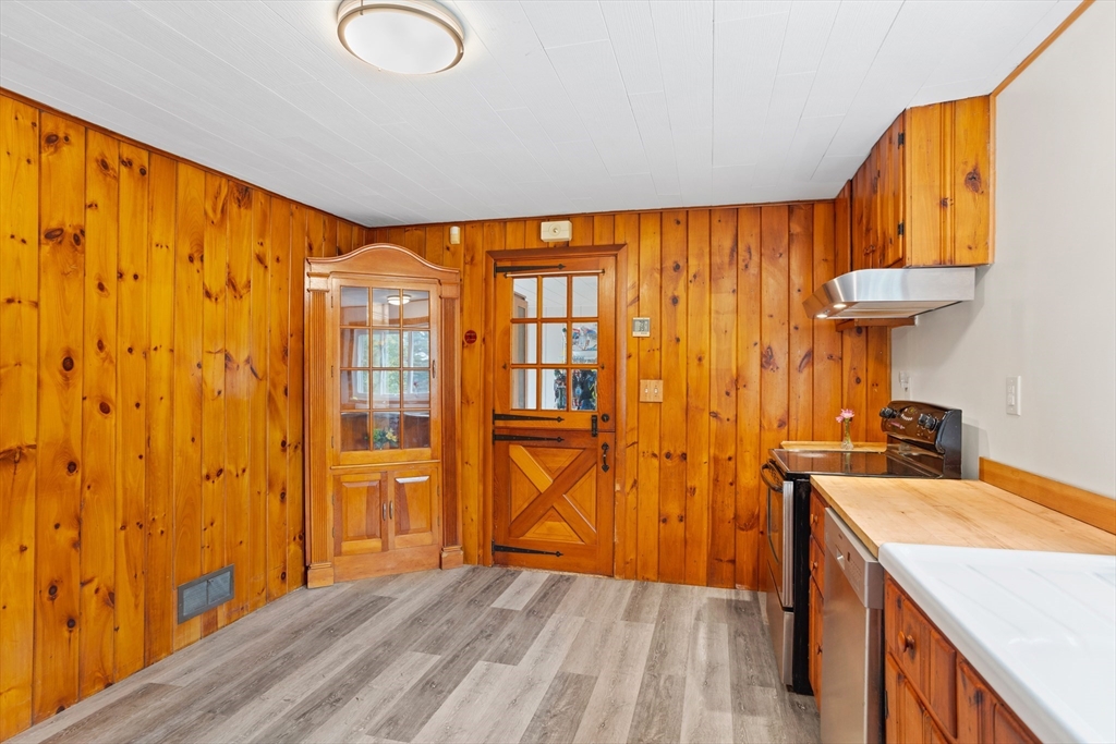 69 East Road Westminster, MA 01473 - Photo 7 of 17 a view of a kitchen with a fridge and wooden floor